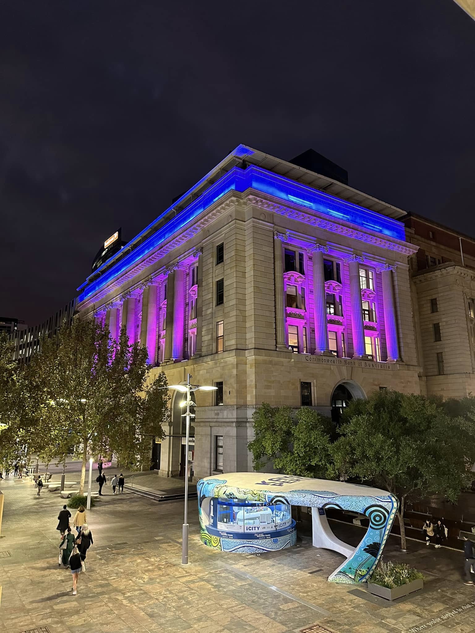 The Commonwealth Bank Building at Forrest Place, Perth, lit in blue and magenta at night.